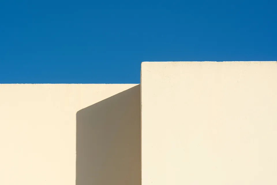 Warm white walls against a deep blue sky
